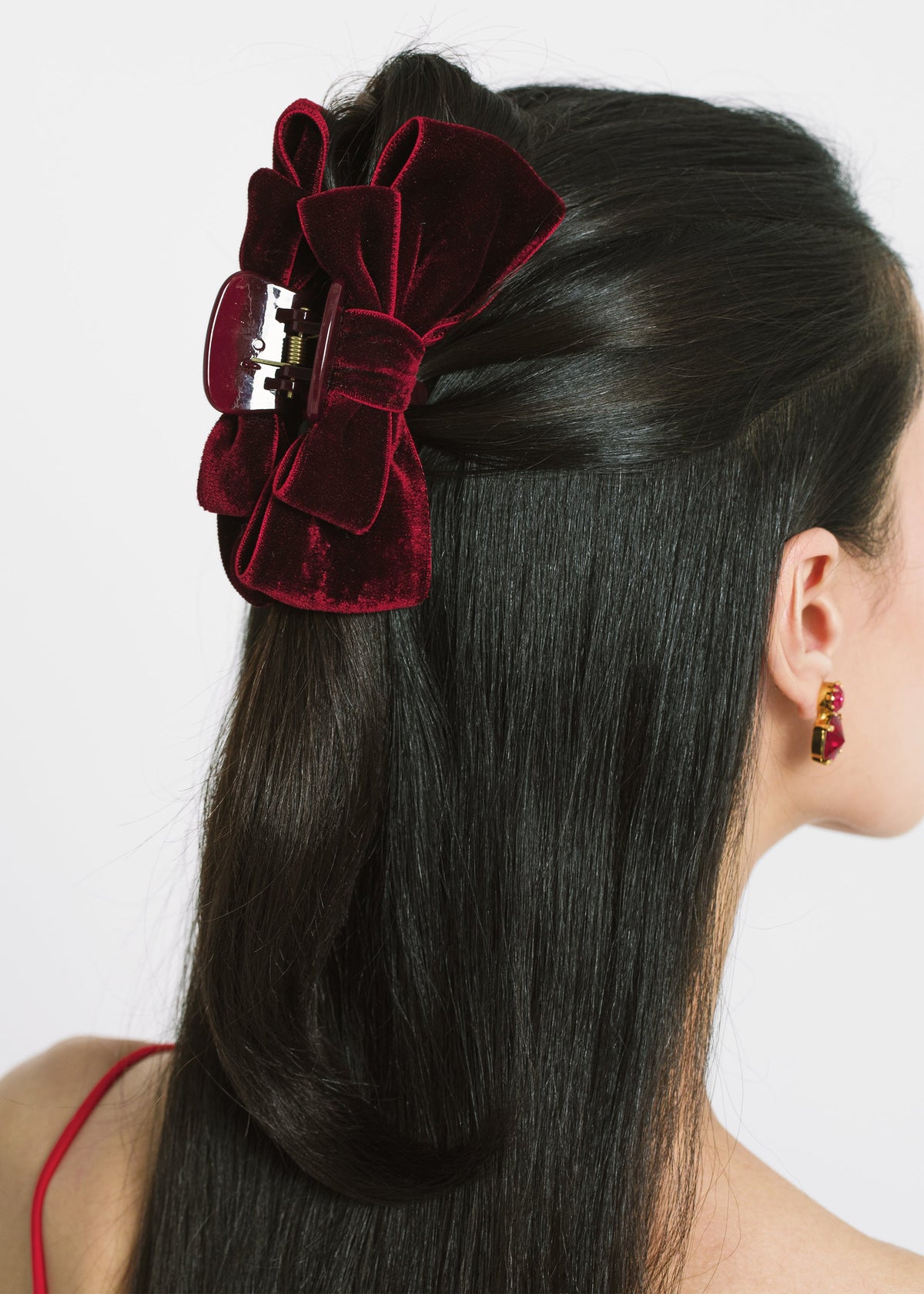 Side view of Matilda Jaw Clip in Pinot showcasing layered velvet bows on an acrylic resin jaw clip worn in model’s dark hair