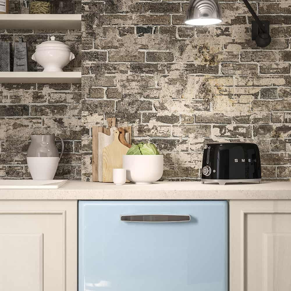 Front-right view of SMEG 2-slice toaster in black showing chrome dial and extra-wide slots on a countertop with brick backsplash