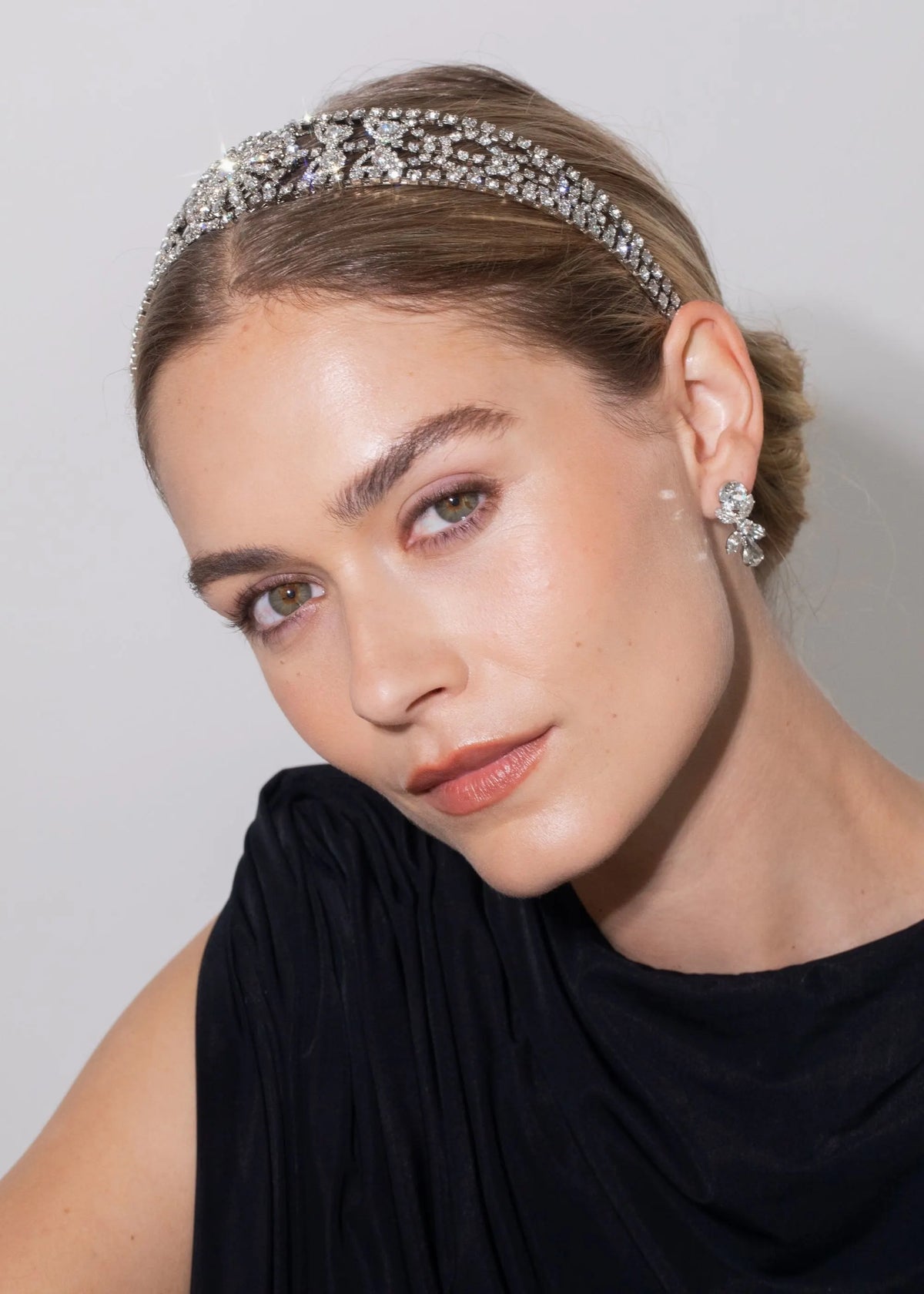 Three-quarter view of ClaraBow Headband in Crystal on model showing Austrian crystal chainwork and central paisley motif