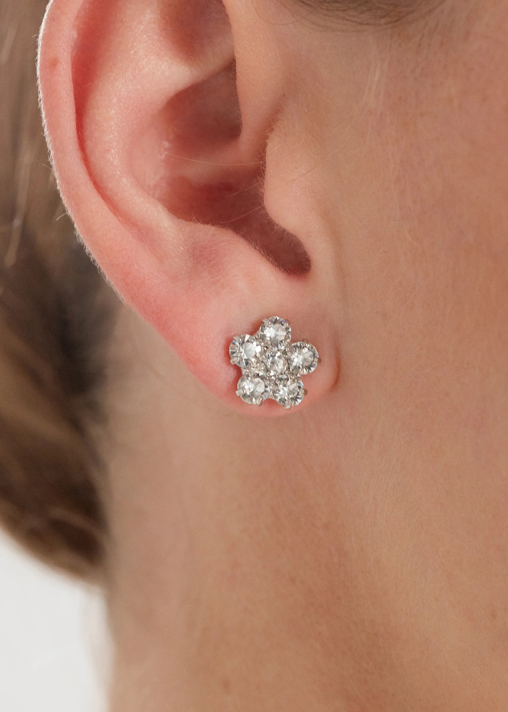 Close-up side view of Daisy stud earring in crystal showing cluster of Austrian crystals on earlobe