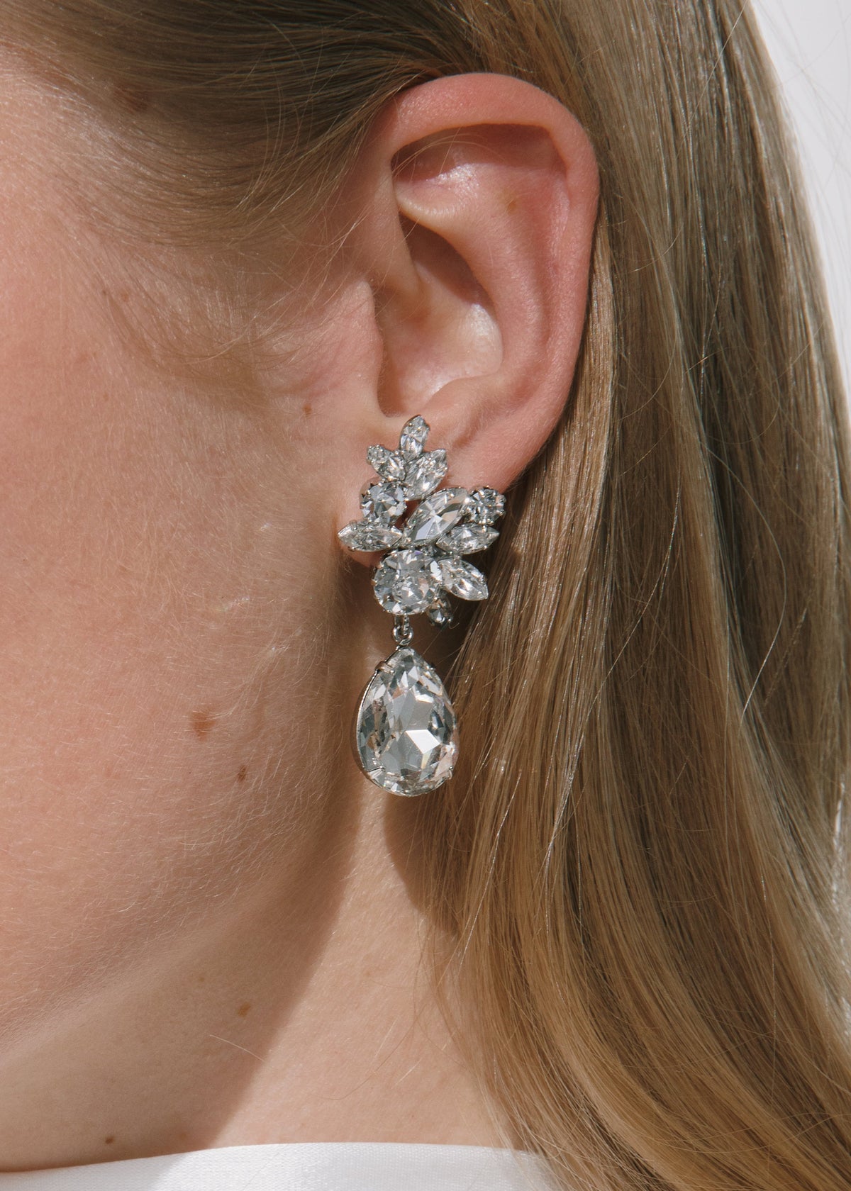 Close-up of Lynlee crystal earrings on model showing clustered Czech crystals and pear-shaped dangling drop