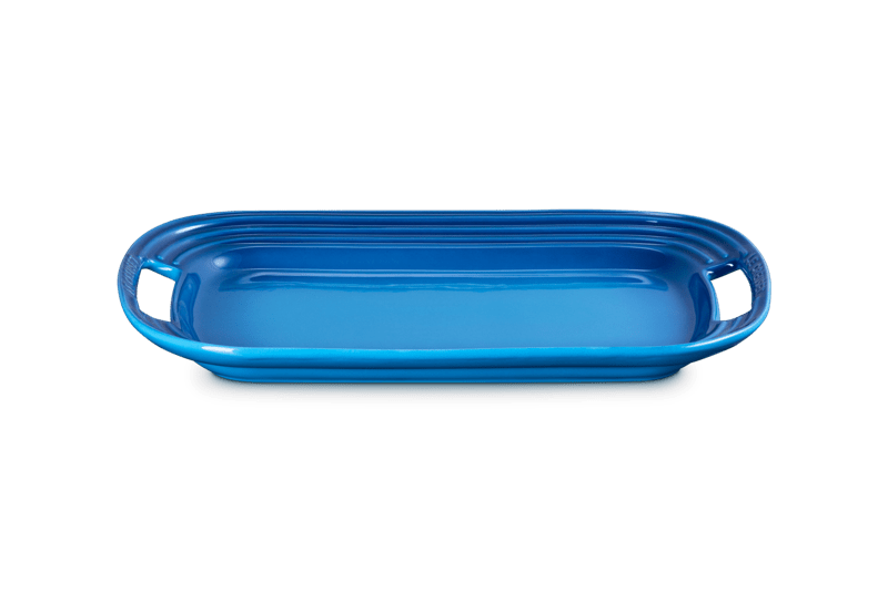 Front view of 14-inch stoneware serving platter in Marseille blue showing integrated handles and ridged edges