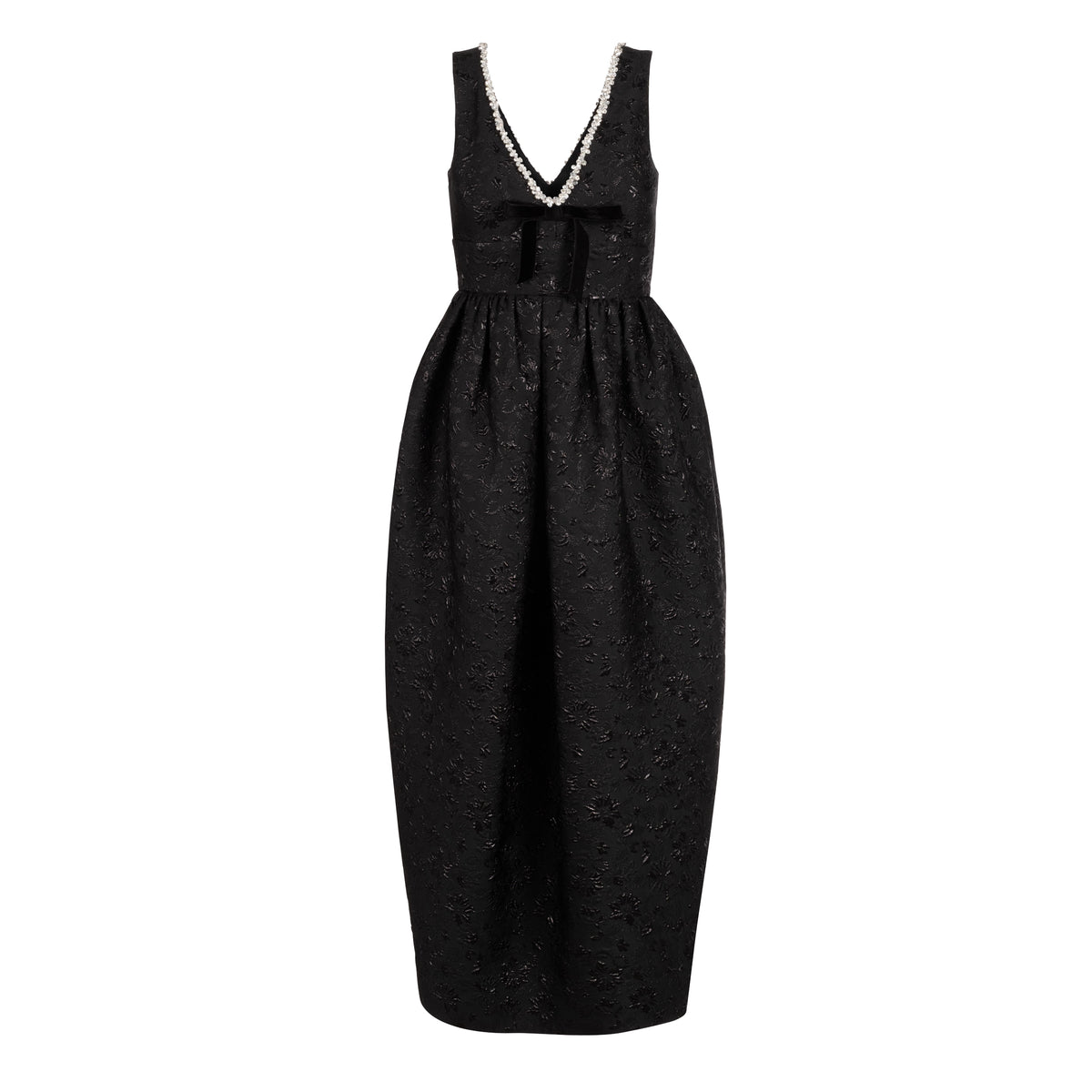 Front view of Rainey dress in black floral brocade showcasing deep V-neck with crystal trim, velvet bow at waist, and puffed tapered midi skirt on white background