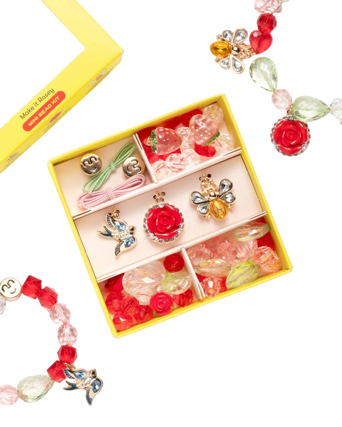 Top view of Make It Rosey Mini Bead Kit showcasing colorful beads and three charms in a yellow box on white