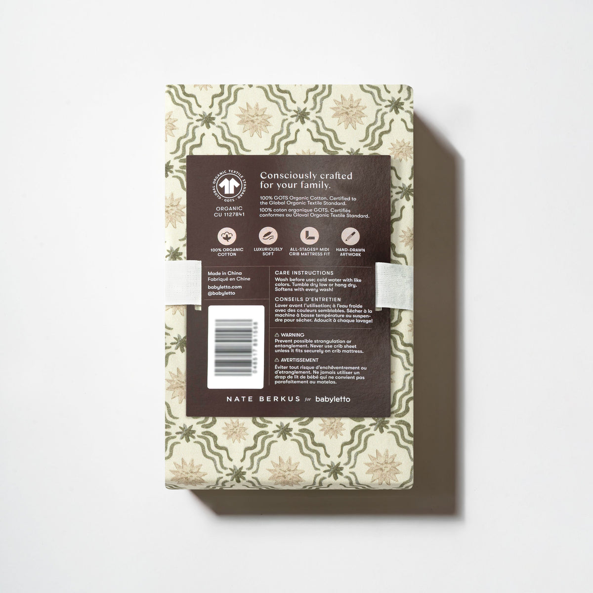 Back view of All Stages Midi Crib Sheet packaging showing Juniper Star pattern and product details on a white background