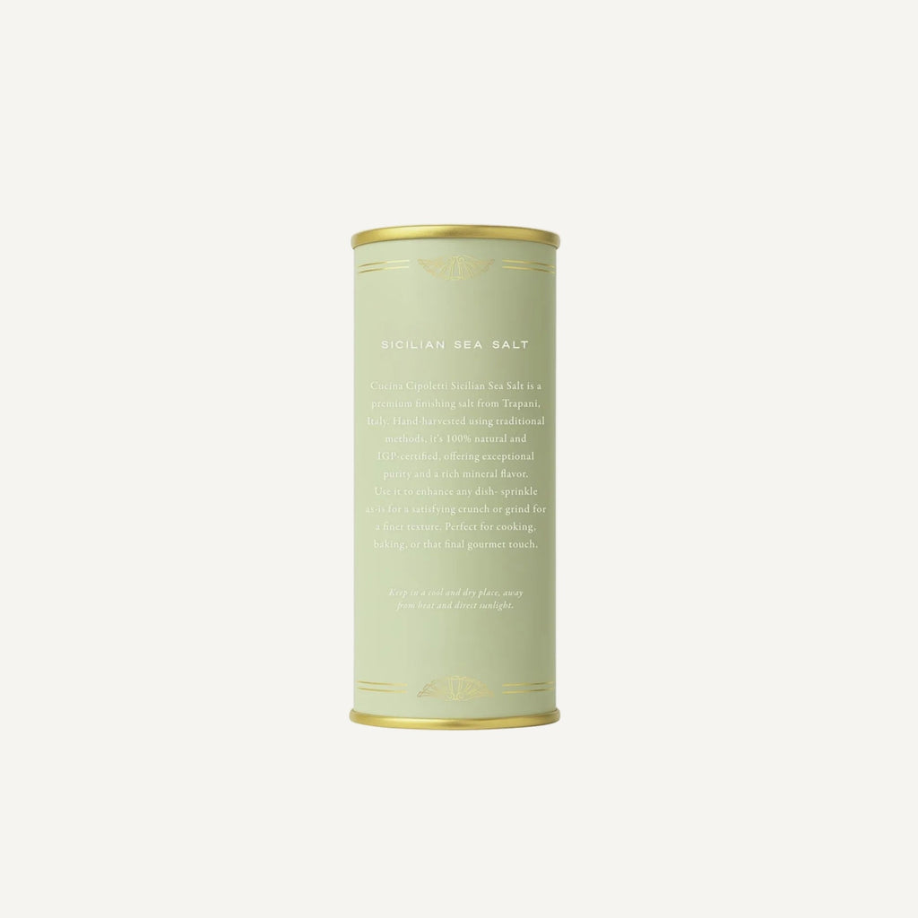 Cylindrical container of sea salt on a white background