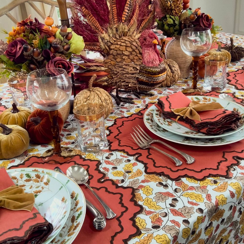 Fall Table Linens Pumpkin Whitley luxury placemat and napkin on acorn leaves tablecloth with gold napkin bow and Thanksgiving china.