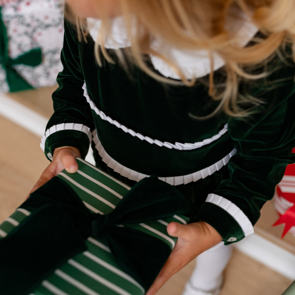Baby girls’ Long Sleeve Grace Bubble in Grafton Green Velvet with a white pleated collar, waist and cuff trim.