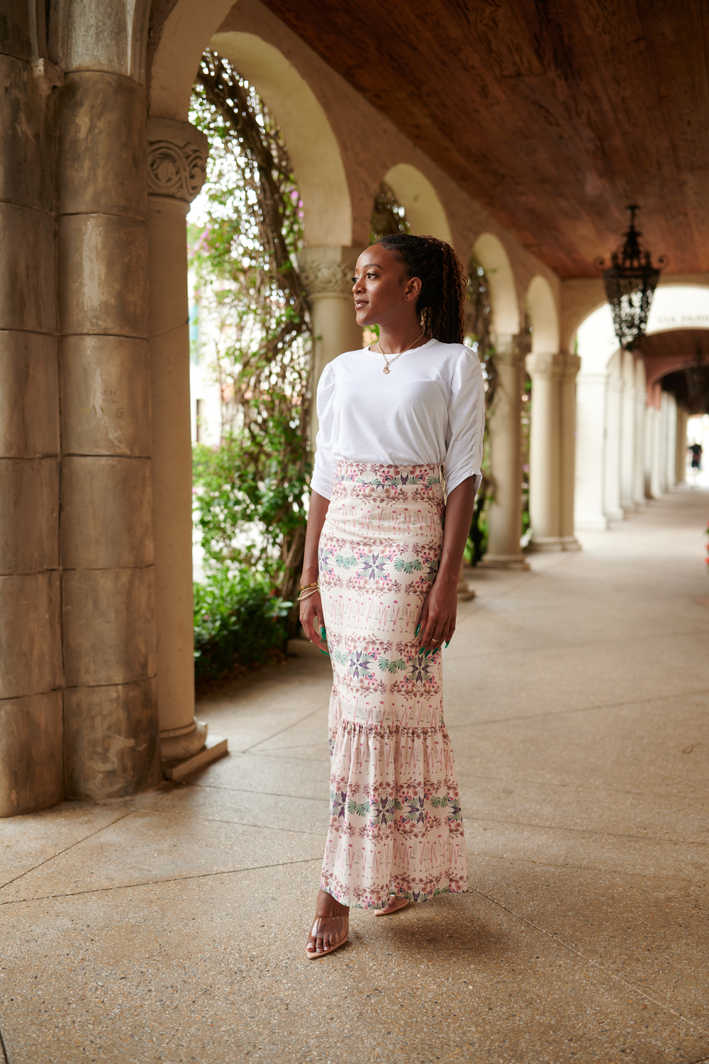 Front view of Lizzie Linen Skirt in Breakfast in the Park, high waist pastel floral maxi worn by model in arched walkway