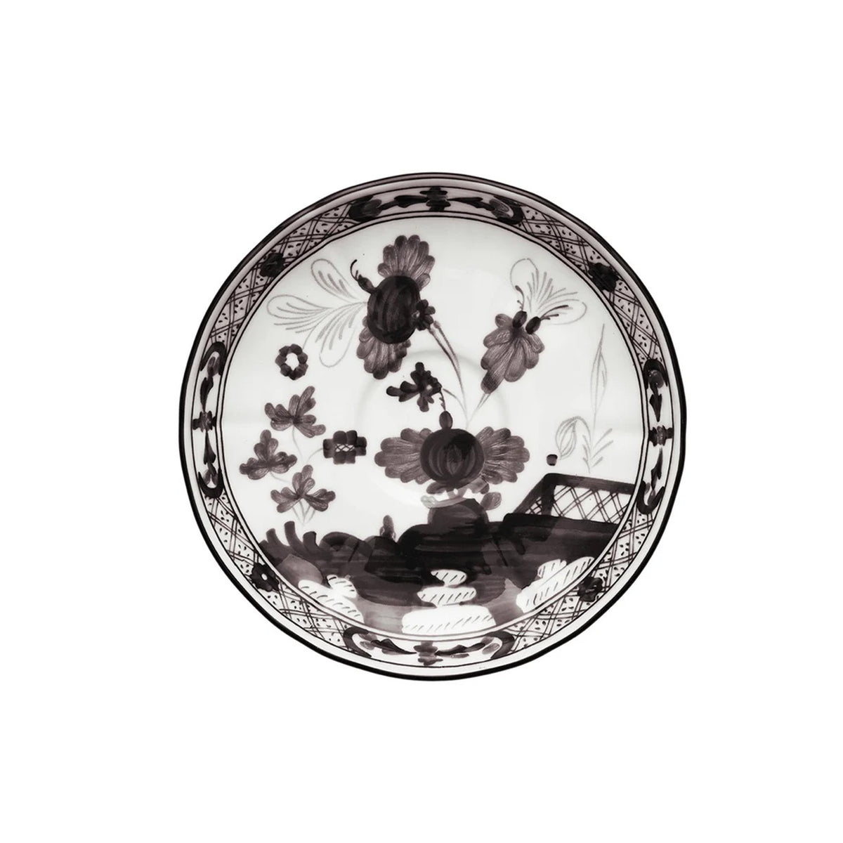 Top view of Oriente Italiano coffee saucer showcasing black floral hand-painted pattern on white porcelain