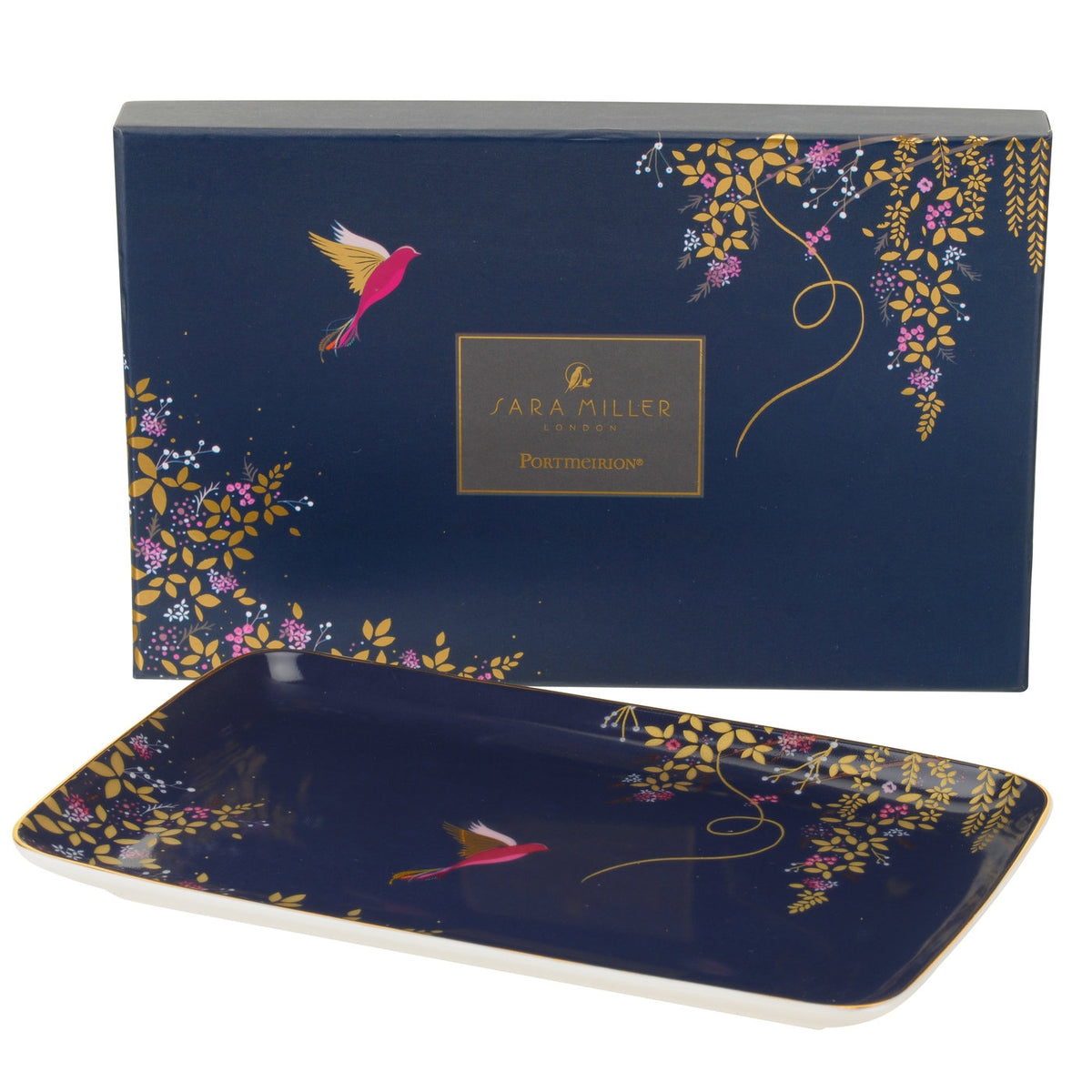 Angled view of Sara Miller Chelsea Collection Trinket Tray with hummingbird and floral gold detailing beside gift box
