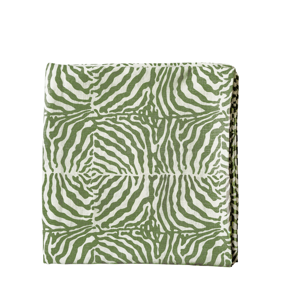 Folded view of Green Zebra tablecloth showcasing green zebra print and linen texture on black background
