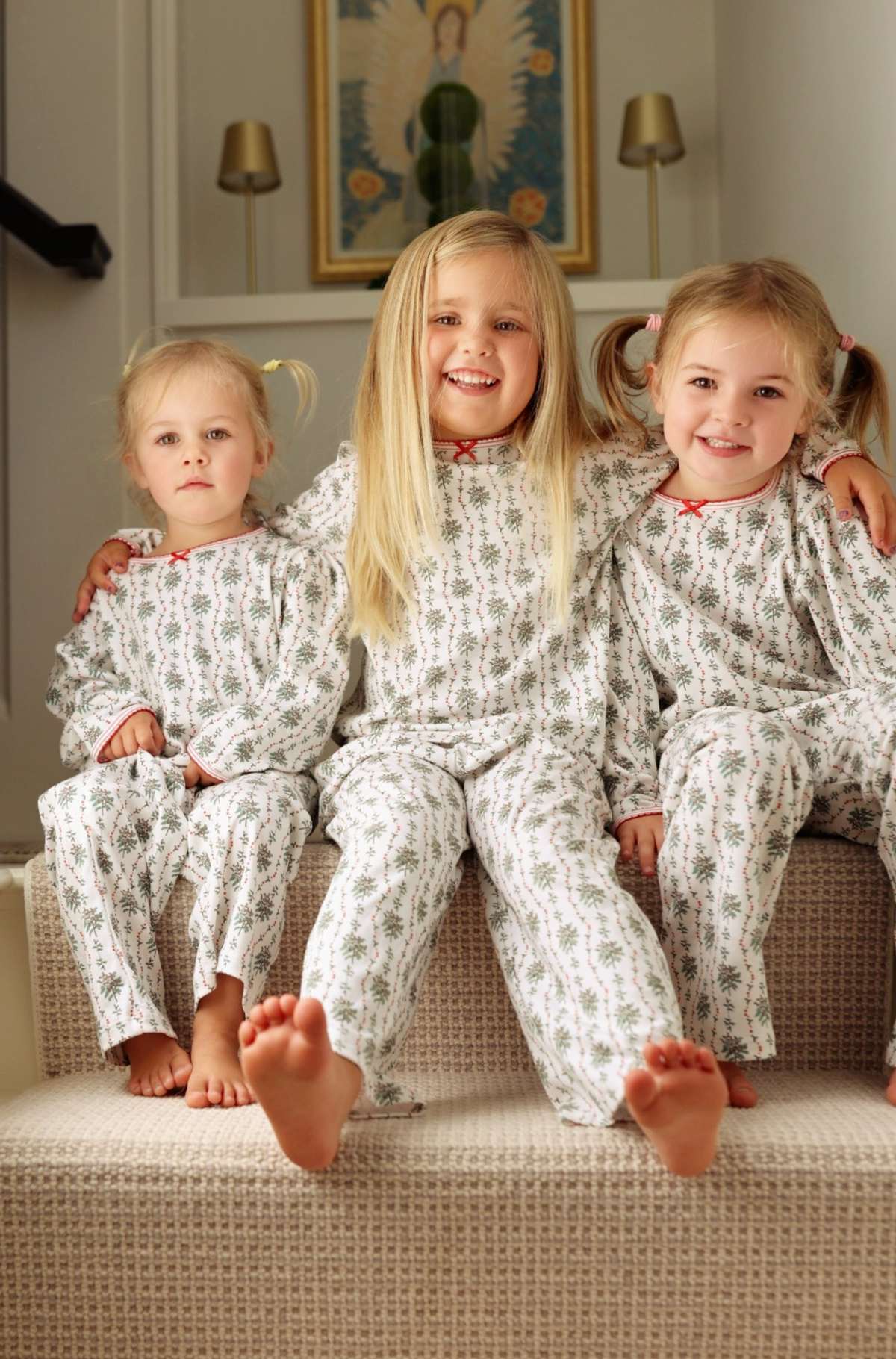 Front view of Holly Long Kids Camp Set, Set of 2 showcasing greenery and red berry prints on children seated on a couch
