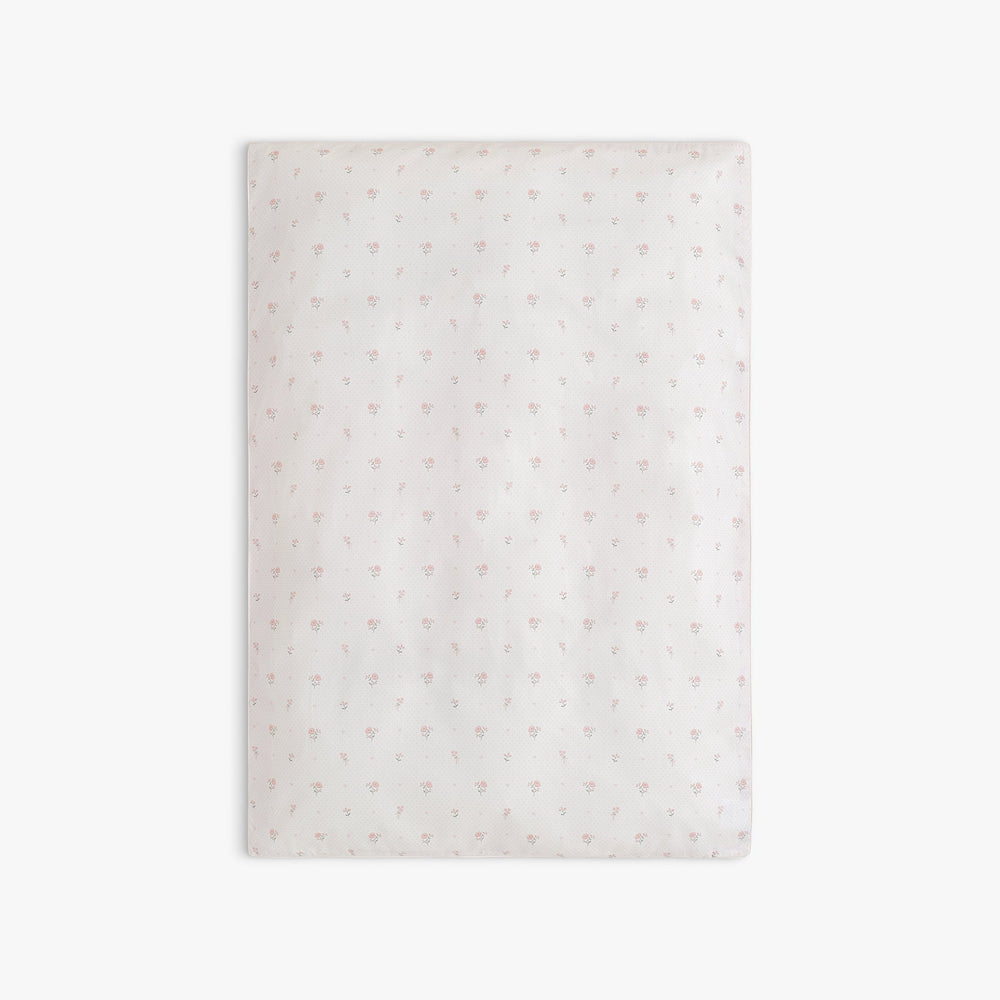 Baby duvet in Ditsy Floral in Pink, laid flat. 