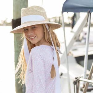 Girls’ long sleeve rashguard one piece swimsuit in Seaside Seersucker with UPF 50+ and scalloped open back, perfect for summer or beach vacations by Henry Duvall.