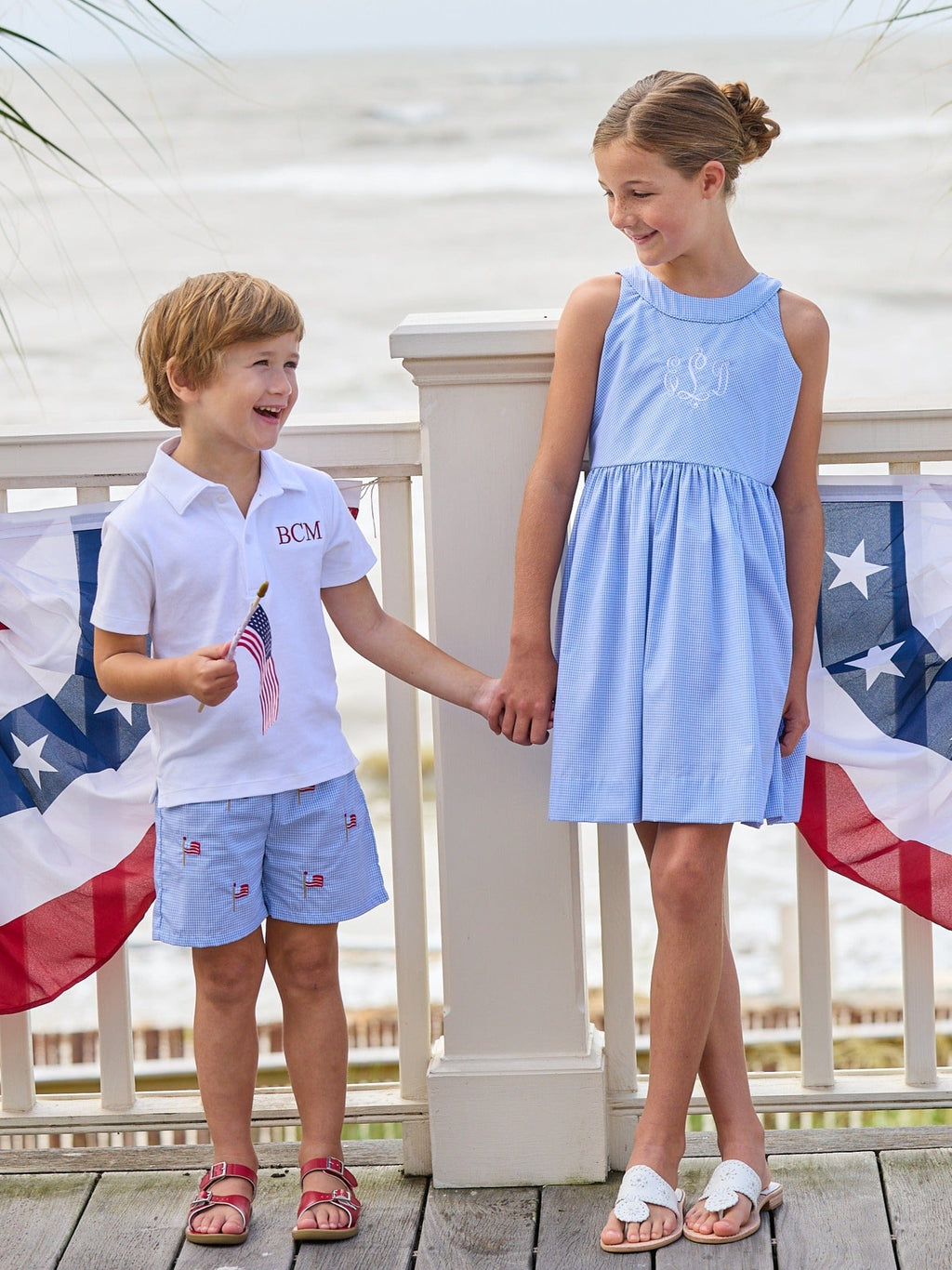 Little English traditional children's clothing.  Royal blue mini gingham sleeveless dress with white ricrac trim and bow tie in back for little girls