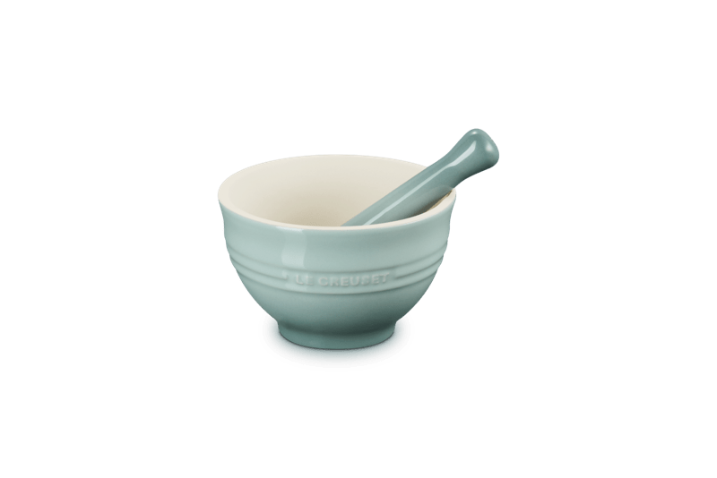 Front-right view of 10 oz Le Creuset mortar and pestle showing unglazed interior and Sea Salt glaze on white background