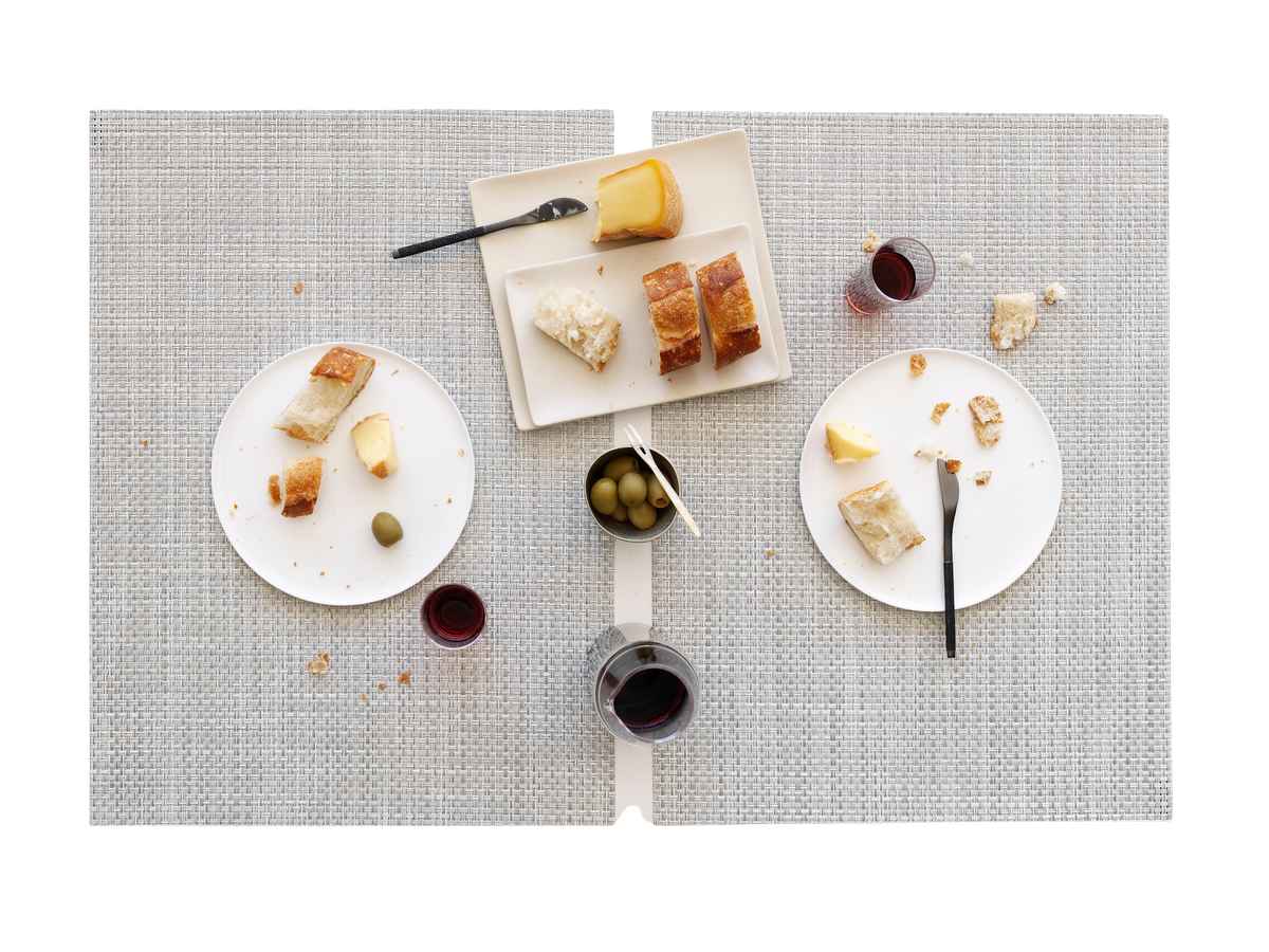 Overhead view of Lattice Placemat showcasing woven lattice texture and light gray color with place settings and glassware on a table