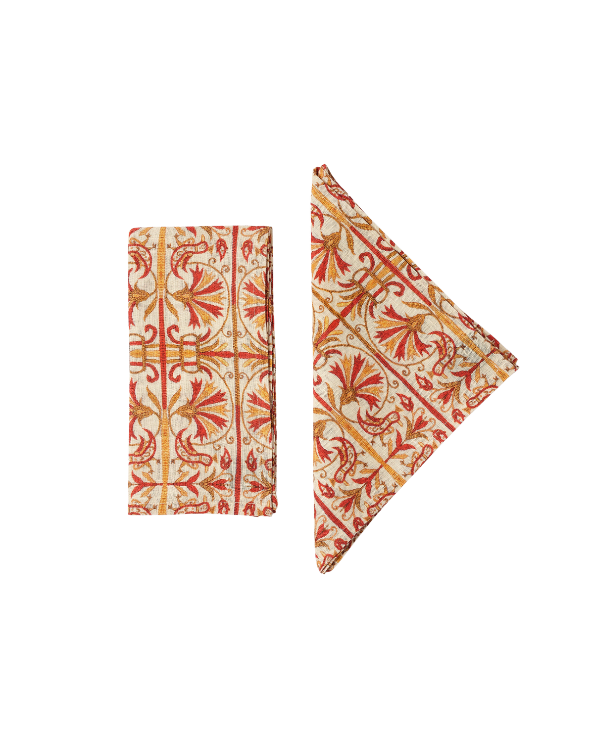 Two views of Creta Napkins showcasing ornate red and gold pattern on cream linen against a black background