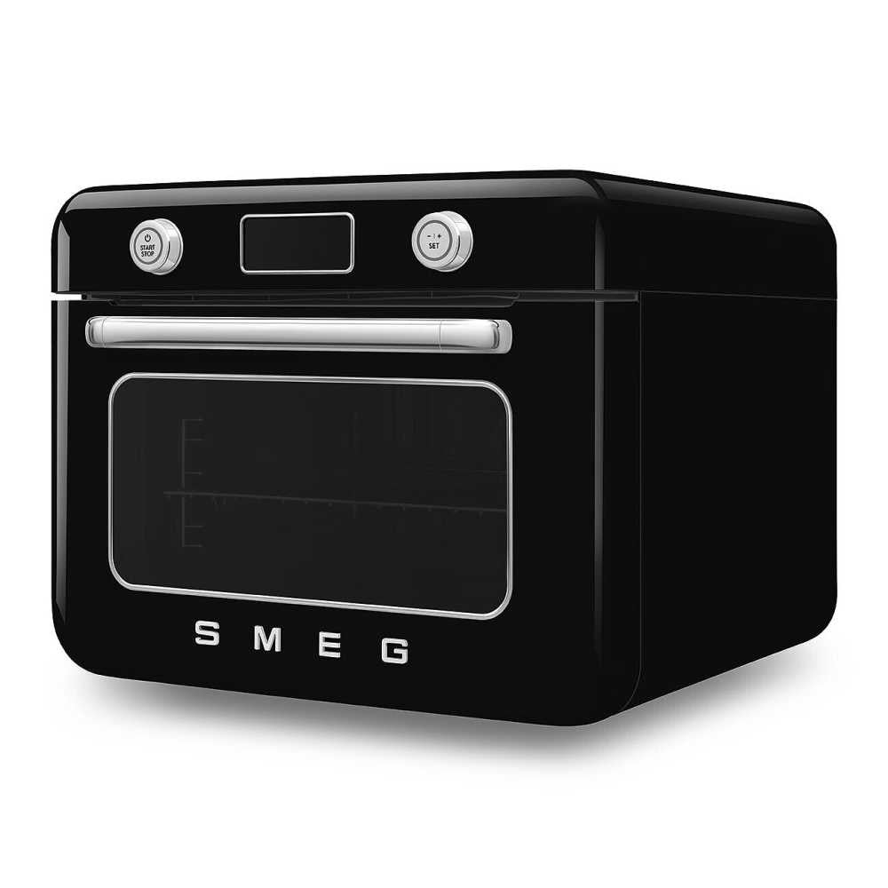 Angled view of Smeg combi countertop oven showing chrome knobs, stainless handle and glass door on white background