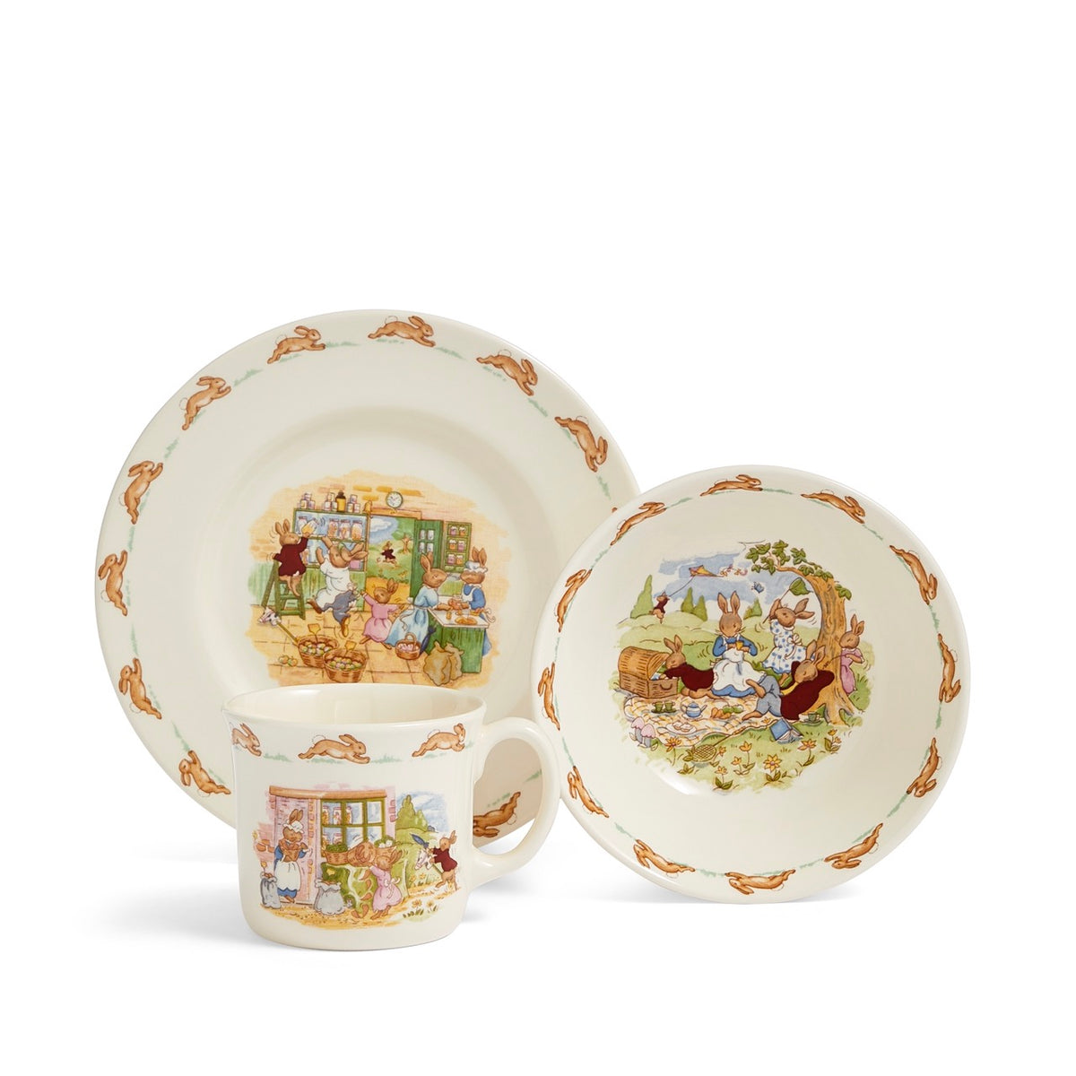 Three-quarter view of Bunnykins children’s 3-piece set showing rabbit storybook scenes and rabbit-border trim on white