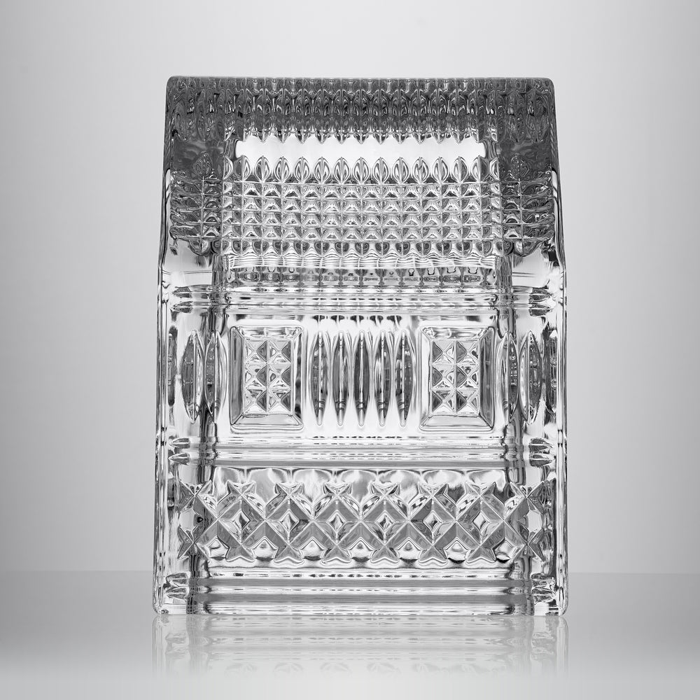 Front view of crystal gingerbread house ornament with Lismore-style diamond and wedge cuts on grey background