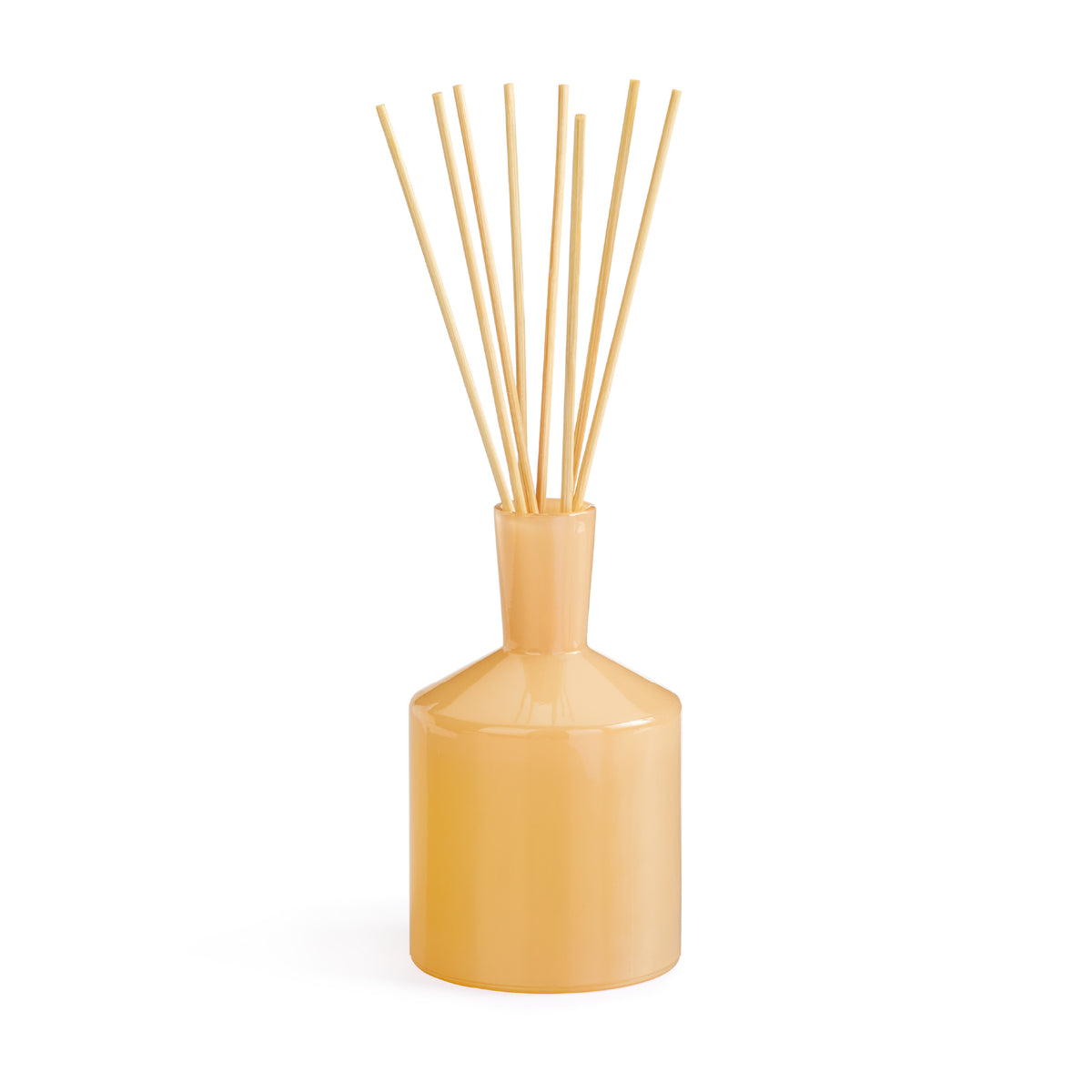 Front view of Paloma Melon Classic reed diffuser showing glossy peach ceramic bottle and natural reed sticks on white background