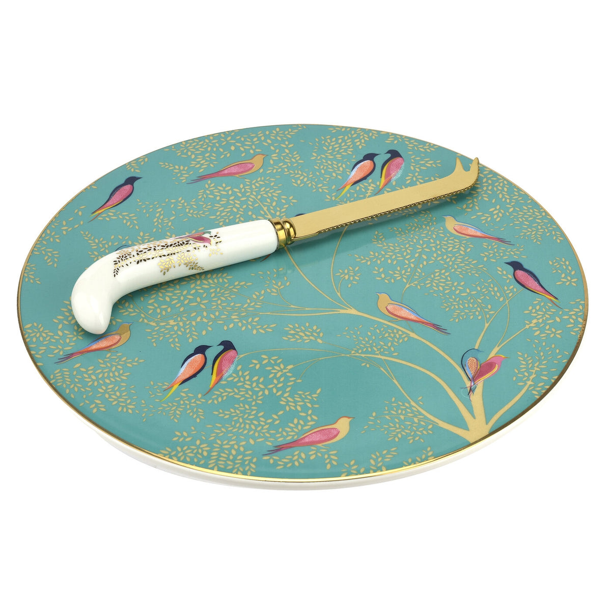 Angled view of Sara Miller Chelsea cheese plate with knife showcasing turquoise bird and tree design with gold detailing