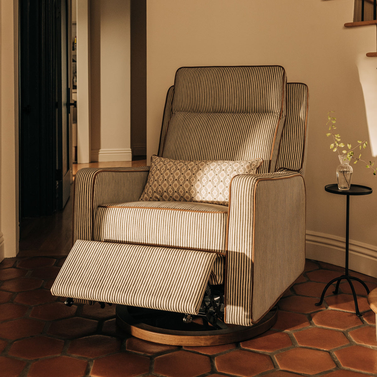 Front view of Sigi Pro Power Recliner and Swivel Glider showcasing olive stripe upholstery and extended footrest indoors
