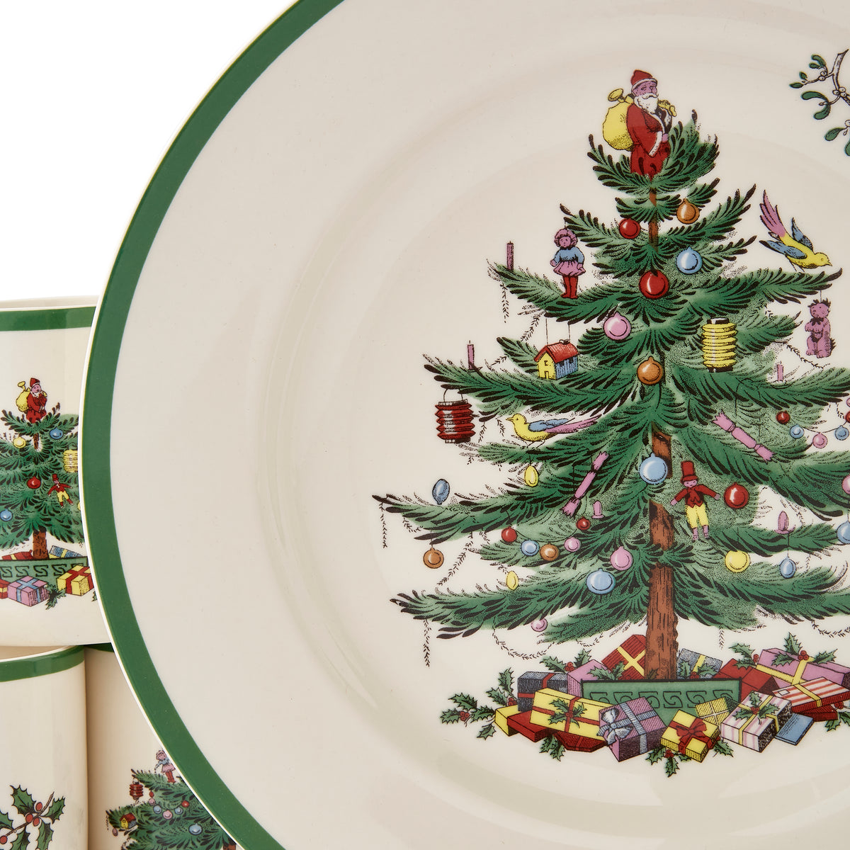 Close-up of Christmas Tree dinner plate showcasing decorated Christmas tree motif and green rim on white background