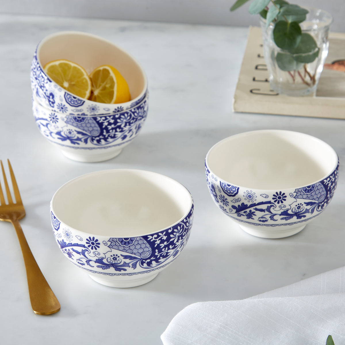 Close-up of Brocato 4.3 inch bowls set of 4 showcasing scroll and floral design on a white table