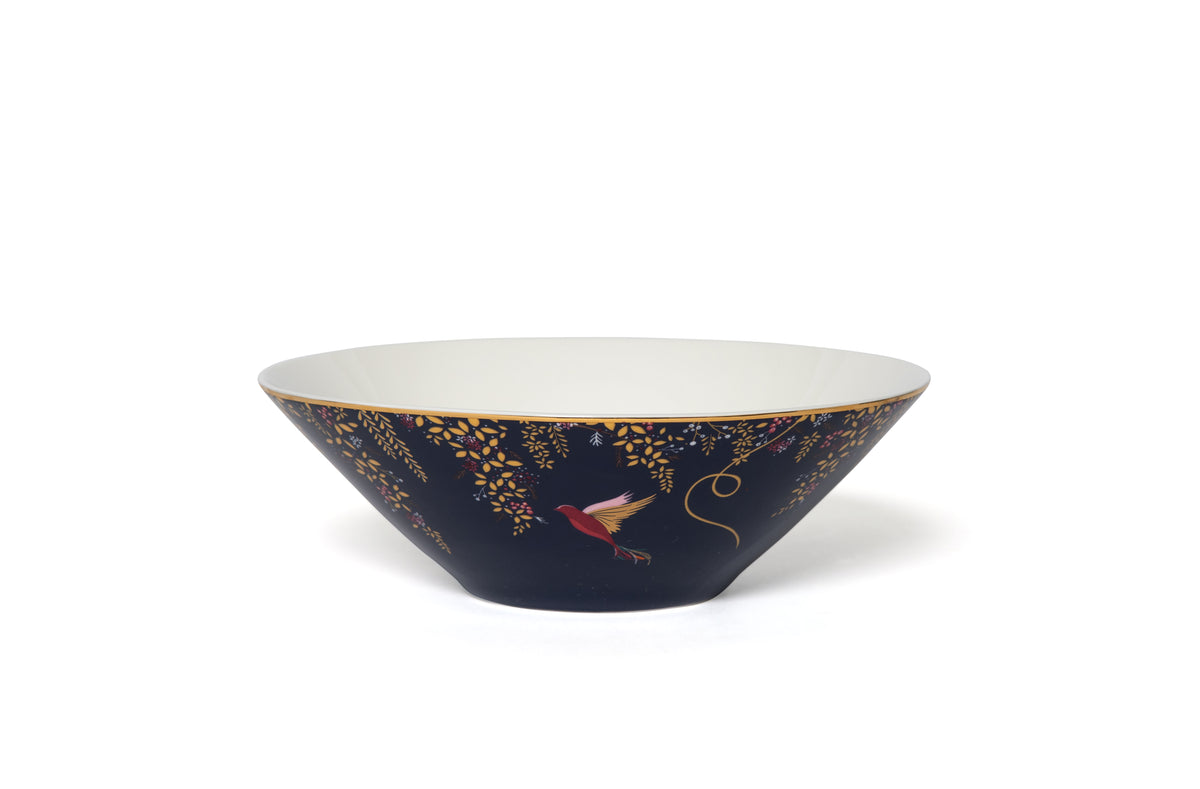 Angled view of Sara Miller Chelsea Collection 8 inch salad bowl showcasing floral bird pattern and 22 karat gold rim on white background