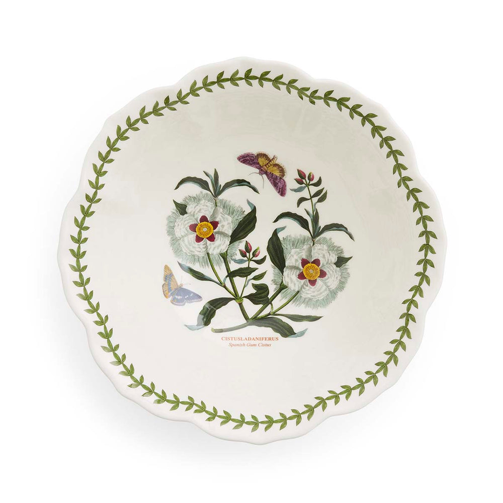 Top-down view of Botanic Garden 10.5-inch salad bowl showcasing scalloped lotus shape, green laurel leaf border, and central Spanish Gum Cistus botanical illustration on white background