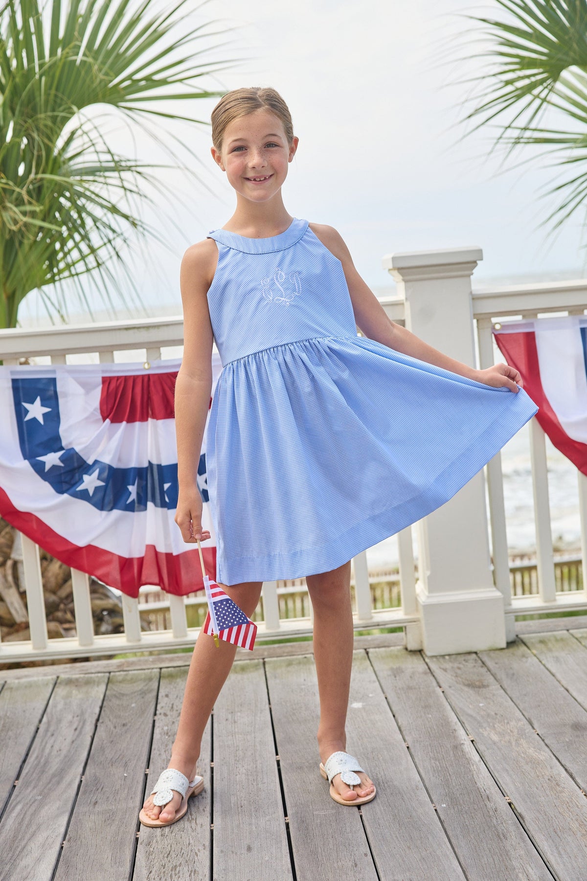 Little English traditional children's clothing.  Royal blue mini gingham sleeveless dress with white ricrac trim and bow tie in back for little girls