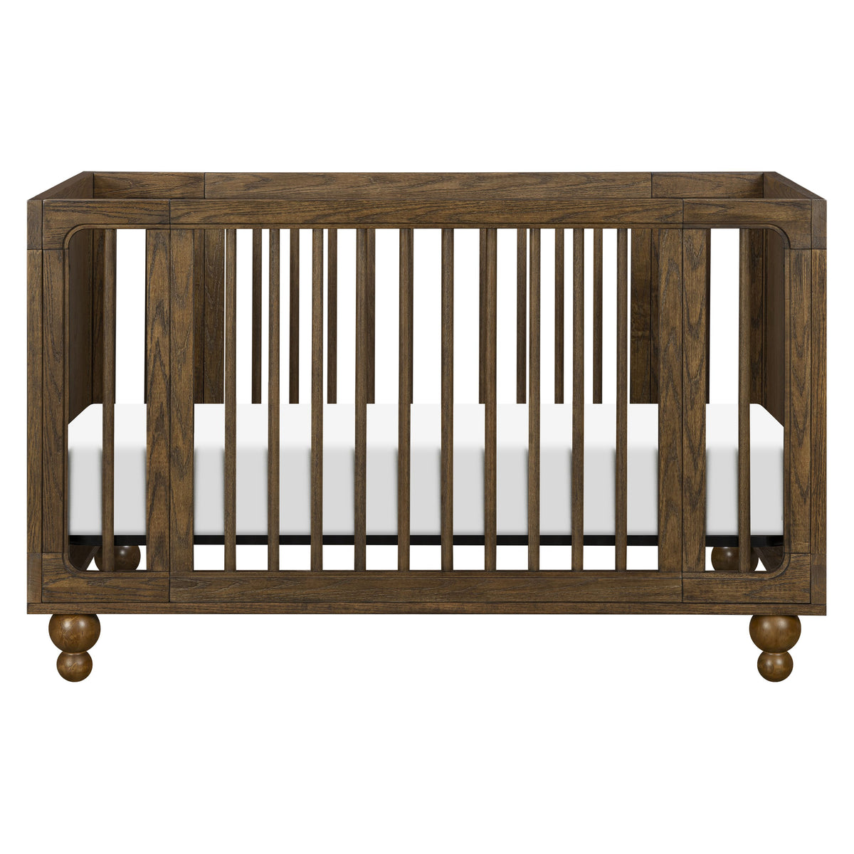 Front view of Astre All-Stages 8-in-1 crib in Toffee showcasing vertical slats and rounded feet on a white background
