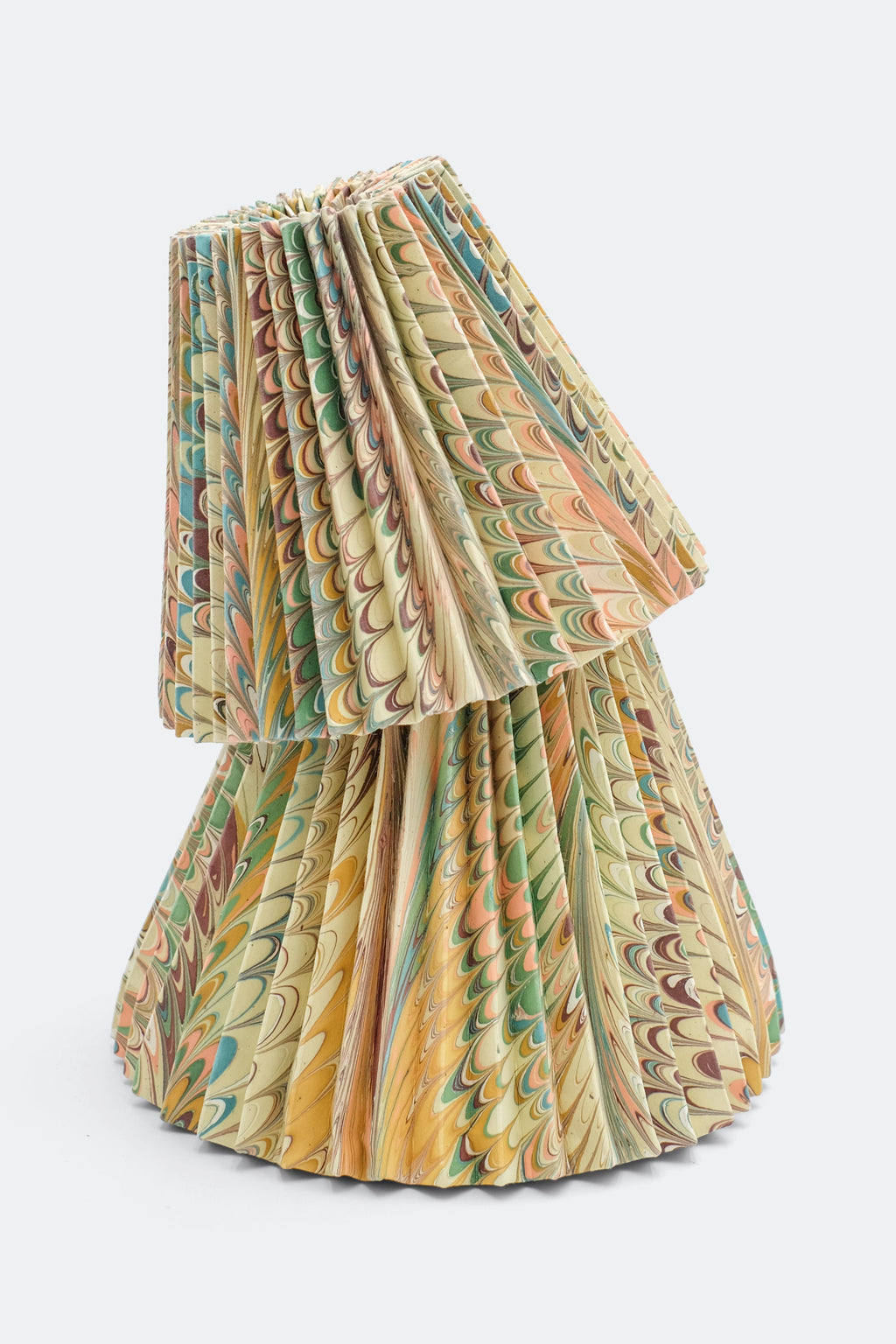 Two stacked hand-marbled pleated lampshades with vibrant patterns