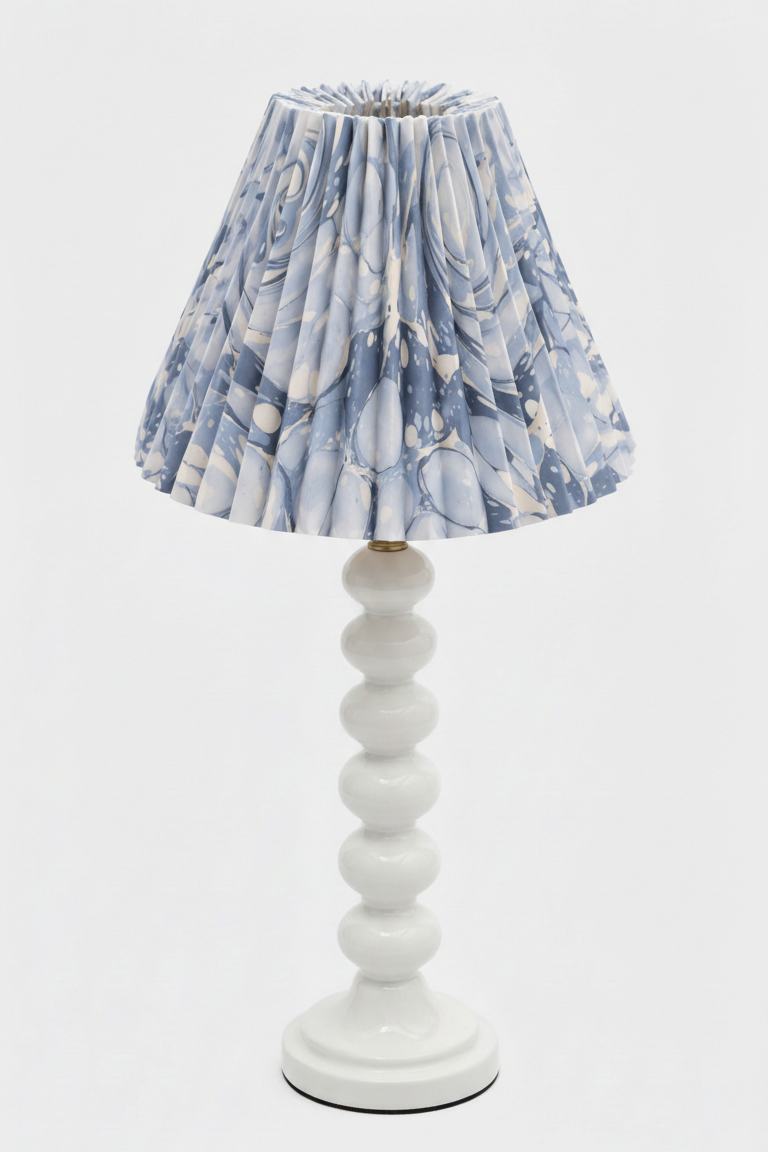 Inner Child table lamp with white stacked base and hand-marbled pleated shade with ocean wave blue patterns
