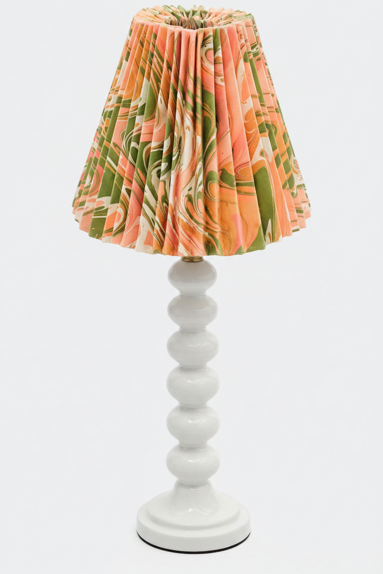 Table lamp with hand-marbled pleated empire lampshade in peony bloom pattern on white base