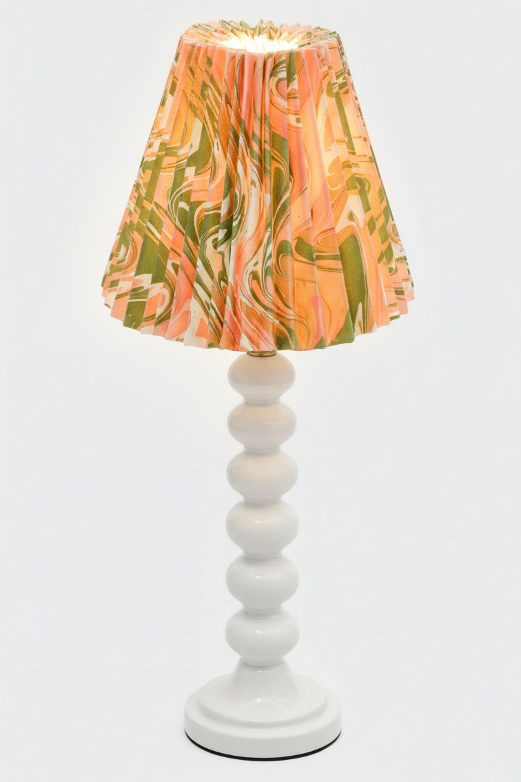Table lamp with hand-marbled pleated empire lampshade in peony bloom pattern on white base