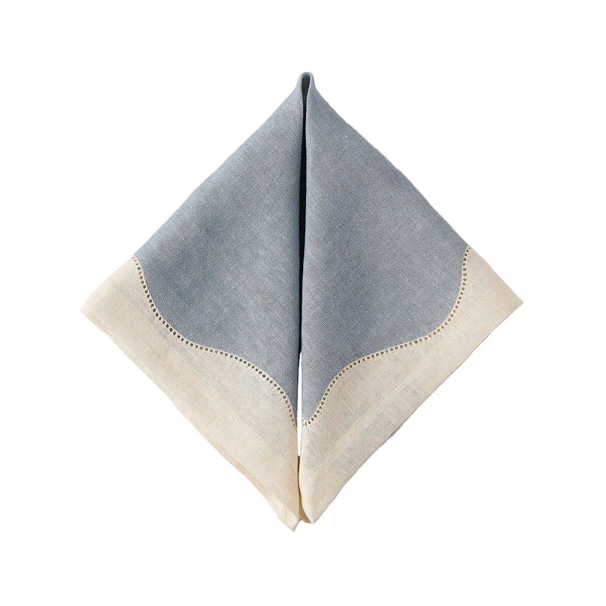 Folded view of Les Courbes Napkin in Celeste showcasing its screen-printed wave motif with a white background