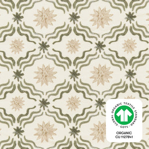 Close-up of the Juniper Star mini crib sheet showcasing wavy lines and star motifs with a GOTS certification badge