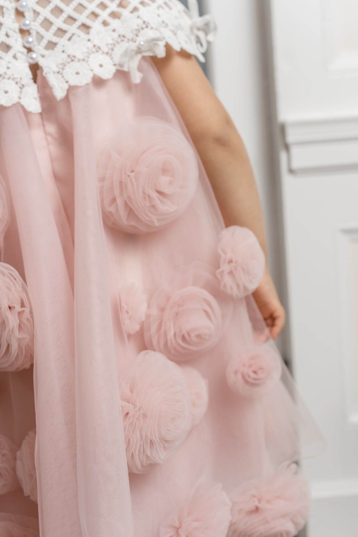 Close up of girls pink tulle dress with 3D flower details