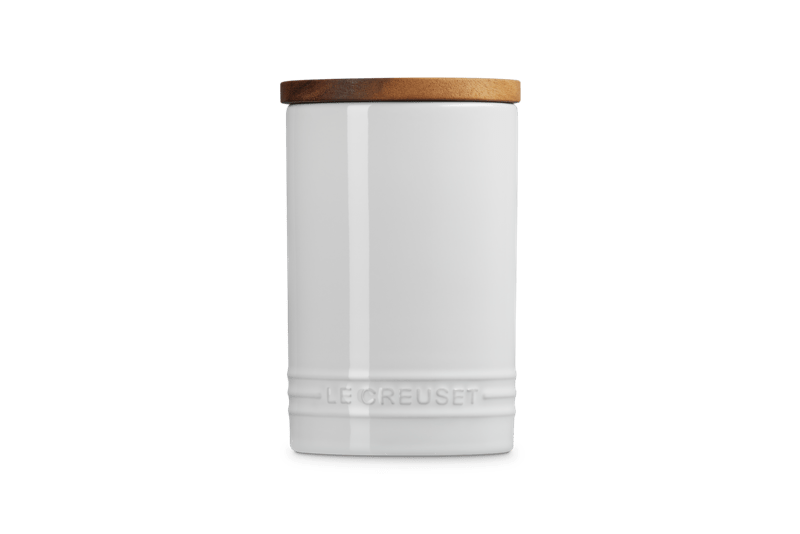 Front of Signature Storage Canister 26 oz showcasing white enamel, wood lid, and embossed Le Creuset logo on white background