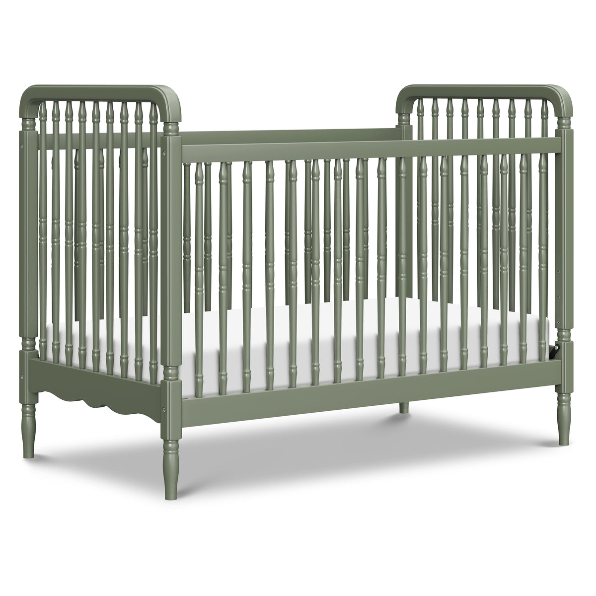 Front three-quarter view of Liberty convertible spindle crib in Juniper showcasing turned spindles on white background