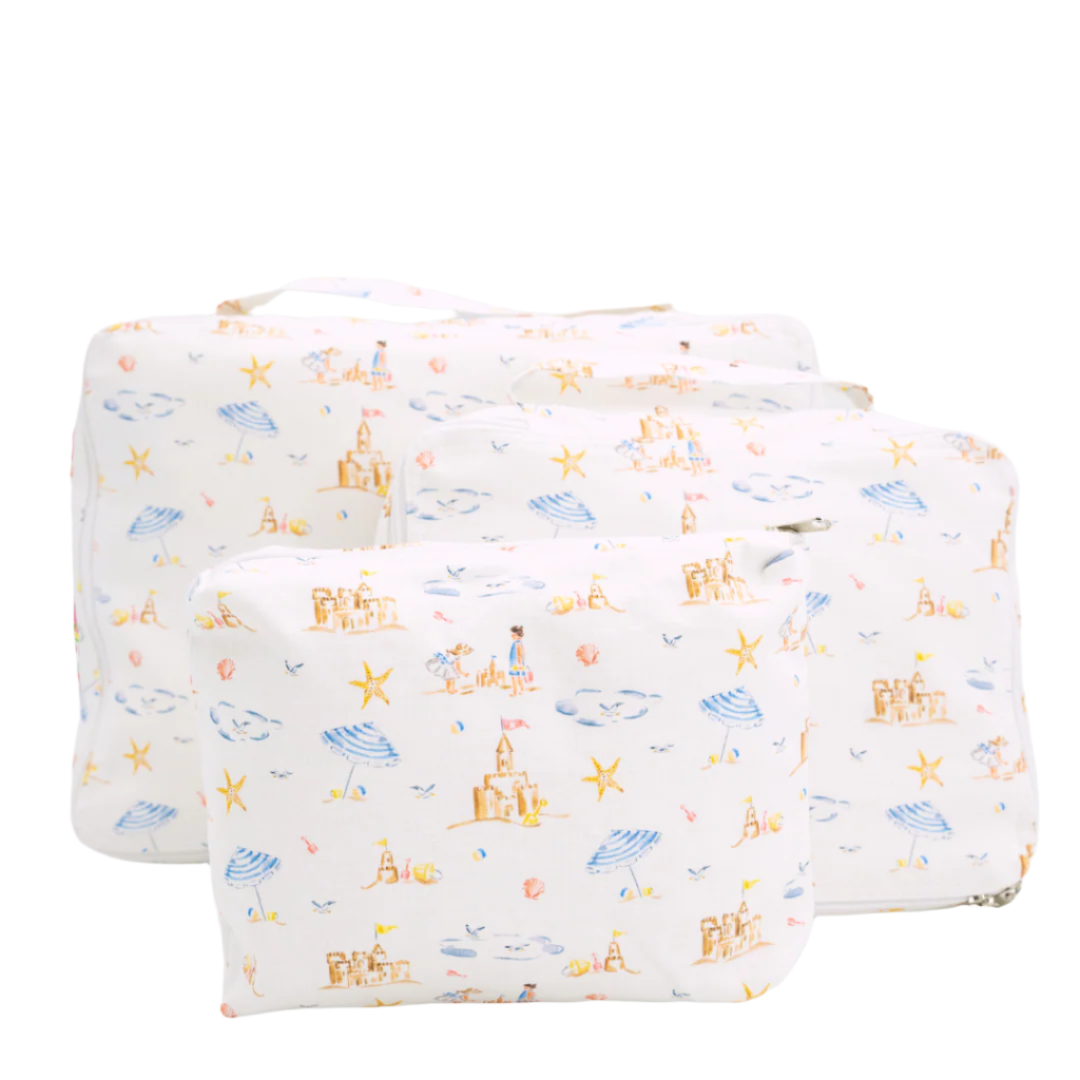 Front view of Sandy Packing Cubes set of three showcasing beach print with sandcastles and umbrellas on a white background