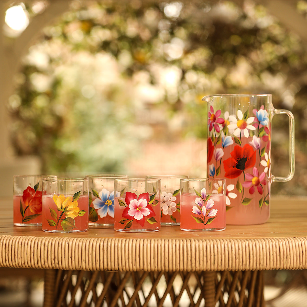 Front view of Wildflowers Jug with Set of 6 Tumblers showcasing hand-painted floral designs with flowers in background
