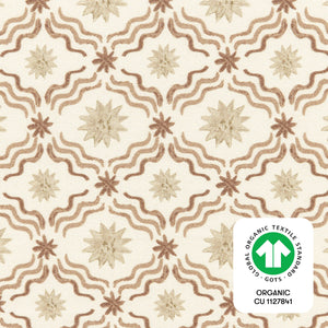 Close-up of All Stages Bassinet Sheet in Autumn Star showing starburst and wavy pattern with GOTS organic textile badge