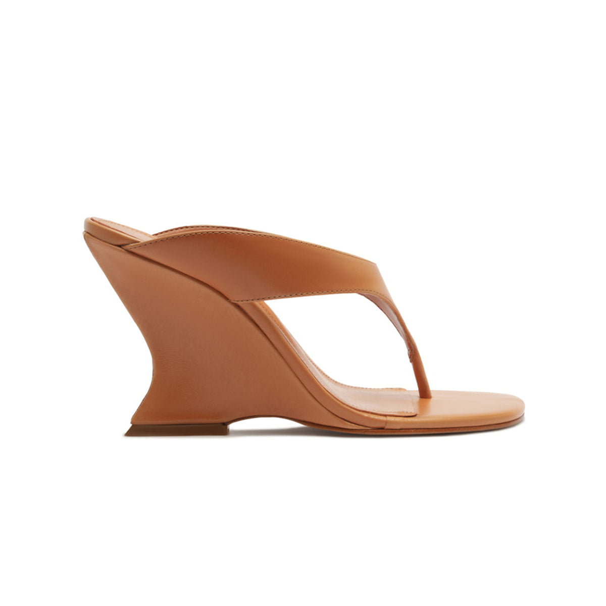 Side view of Maya leather sandal in Earth Clay showcasing sculpted wedge heel and thong-style upper on white background