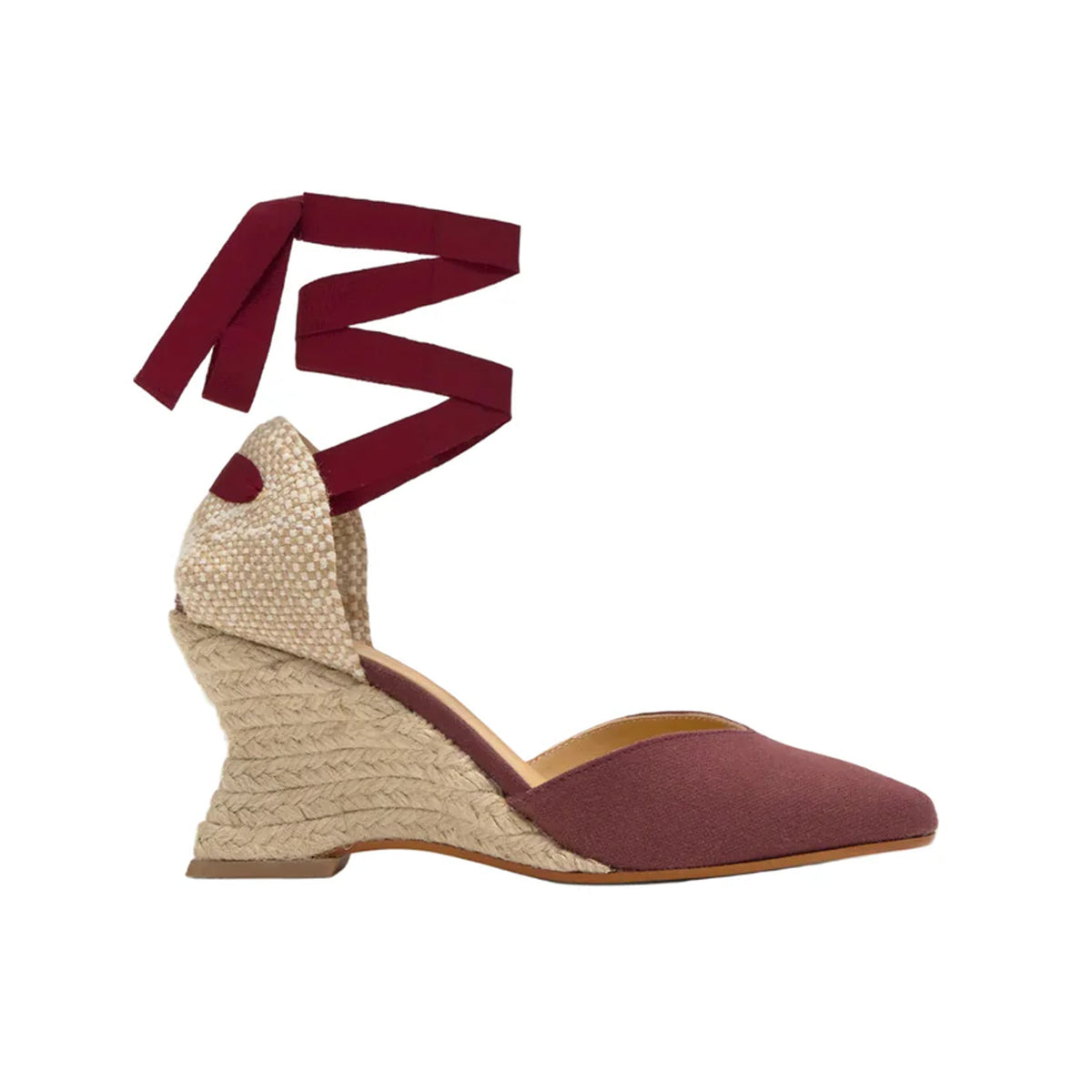 Side view of Jud espadrille in wine showing pointed toe, lace up ankle ribbons and jute wedge on white background