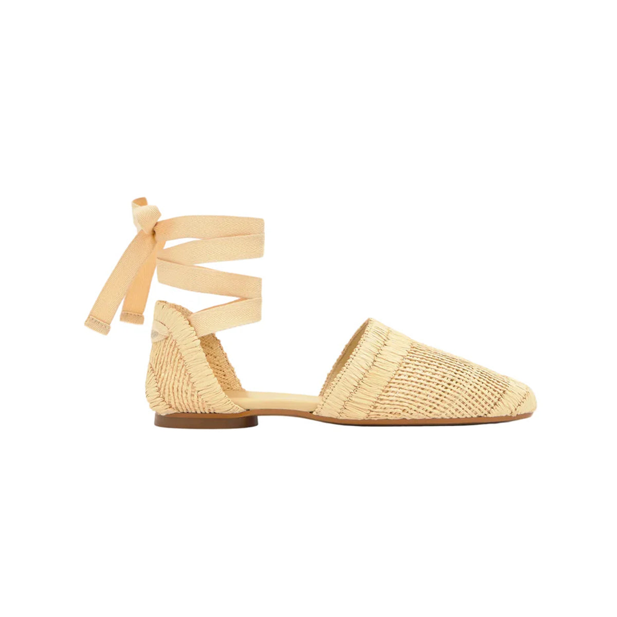 Side view of Goldie espadrille in natural showing woven raffia upper, ankle ribbon ties and jute midsole on white background